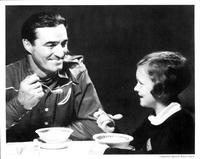 Tom Mix eats cereal with a little girl