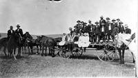 Buckboard wagon with Native Americn boys & girls