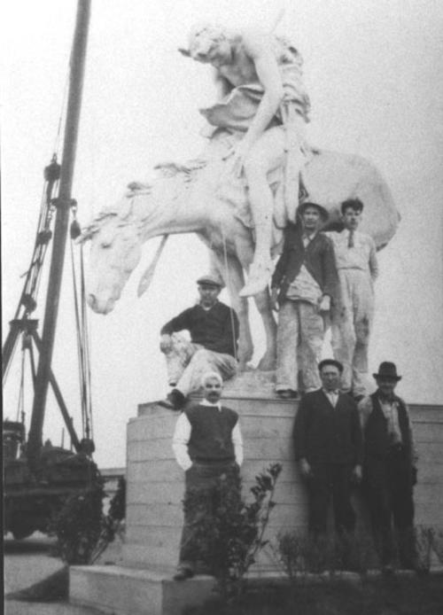 Contini and 5 other men on or near base of End of the Trail Plaster with Crane to left.