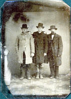Three men in overcoats, boots & hats
