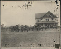 [Cowboys on horseback and stagecoach in front of the first 101 Ranch headquarters]