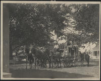 [3 women, 2 men and a boy sitting on a stagecoach with a man on horse back next to the stagecoach]