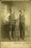 Two Cowboys with firearms in studio pose