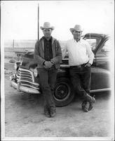 Everett Shaw and Dick Truitt posing in front of car