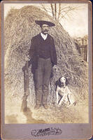 Hunter with dog and haystack
