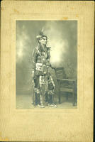 Unidentified Standing Native American Man in dance outfit