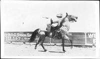 [Unidentified cowgirl, possibly Mayme Stroud, trick riding]