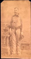 Utah cowboy in fringed attire with two holstered pistols