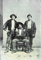 Three cowboys with chair