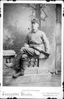 Armed hunter, seated