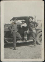 [Group portrait of Bob Askin and others around an automobile]
