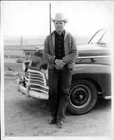 Everett Shaw in front of black car