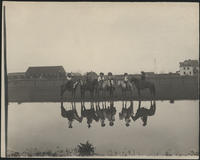 [6 cowgirls on horseback with reflection in pond]