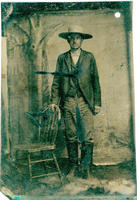 Man wearing knee high boots and brimmed hat