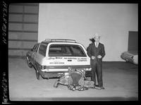 Larry Mahan - car & saddle outside
