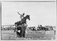 Leonard Stroud riding Black Diamond over human hurdle jump, Colorado State Fair 1927