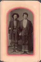 Portrait photograph of two standing men wearing coats