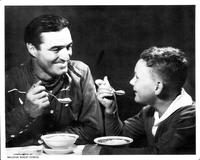 Tom Mix eats cereal with a little boy