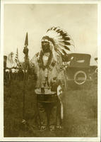 Native American with American flags and automobiles