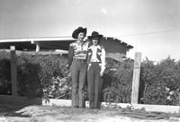 [Possibly Margie Greenough standing beside unidentified cowgirl]