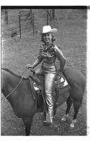 [Mary Louise Eskew, sitting atop horse, poses for November 1969 Western Outfitter article]