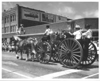 [Horse-drawn fire wagon with firemen]