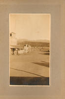 [Unidentified town's main street showing facade of General Merchandise store]