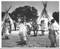 [Indian dancers in front of tipis]