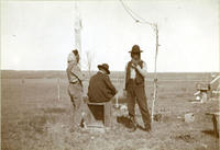 [Three Indian men near possible telegraph pole]