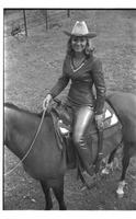 [Madonna Eskew, sitting atop horse, poses for November 1969 Western Outfitter article]