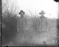 [Two Farmers or Ranchers in an open field]