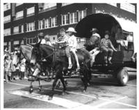 [Children on horse team pulling wagon with other children]
