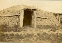[Large Hogan of mud brick or adobe showing entryway]