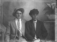[Single portrait of two young Men sitting]