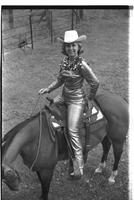 [Madonna Eskew, sitting atop horse, poses for November 1969 Western Outfitter article]