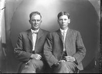 [Single portrait of a young Man and an adult Man sitting]