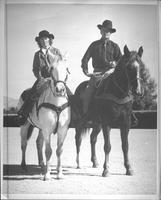 [Probably Glorene Tindall & Jack Webb posed atop horses]