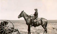 [Unidentified woman in profile atop saddled horse]