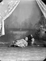 [Carte de Visite single portrait of an young Girl lying on floor with dog]