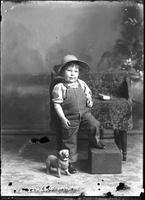 [Single portrait of young Boy wearing a pair of overalls]