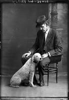 Single portrait of Dr. W.C. Whittenberg sitting with dog