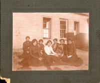 Probably Carlisle Indian School [Sitting Indian women, perhaps students, flanking teacher(?)]