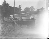 [Two men & a boy in a rowboat fishing]