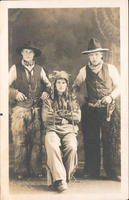 [Three Canadians costumed as two cowboys and an Indian]