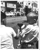 [Two boys with puppy at the parade]