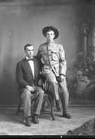 [Single portrait of a young Male Oklahoma A&M cadet and an adult Male sitting]