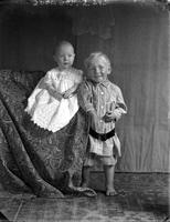 [Carte de Visite single portrait of an young Boy standing & an Infant sitting]