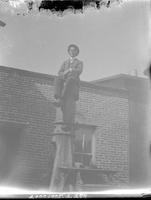 Man sitting atop pole