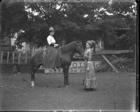 [Single portrait of two people and a horse]