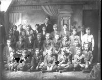 [Single portrait of a group of children and a person]